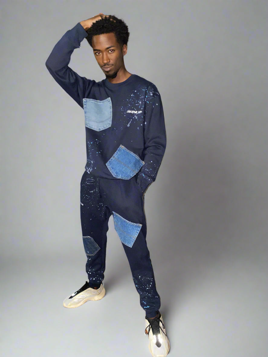 A male model wearing high-waisted, denim-look joggers with pockets and drawstring waist.