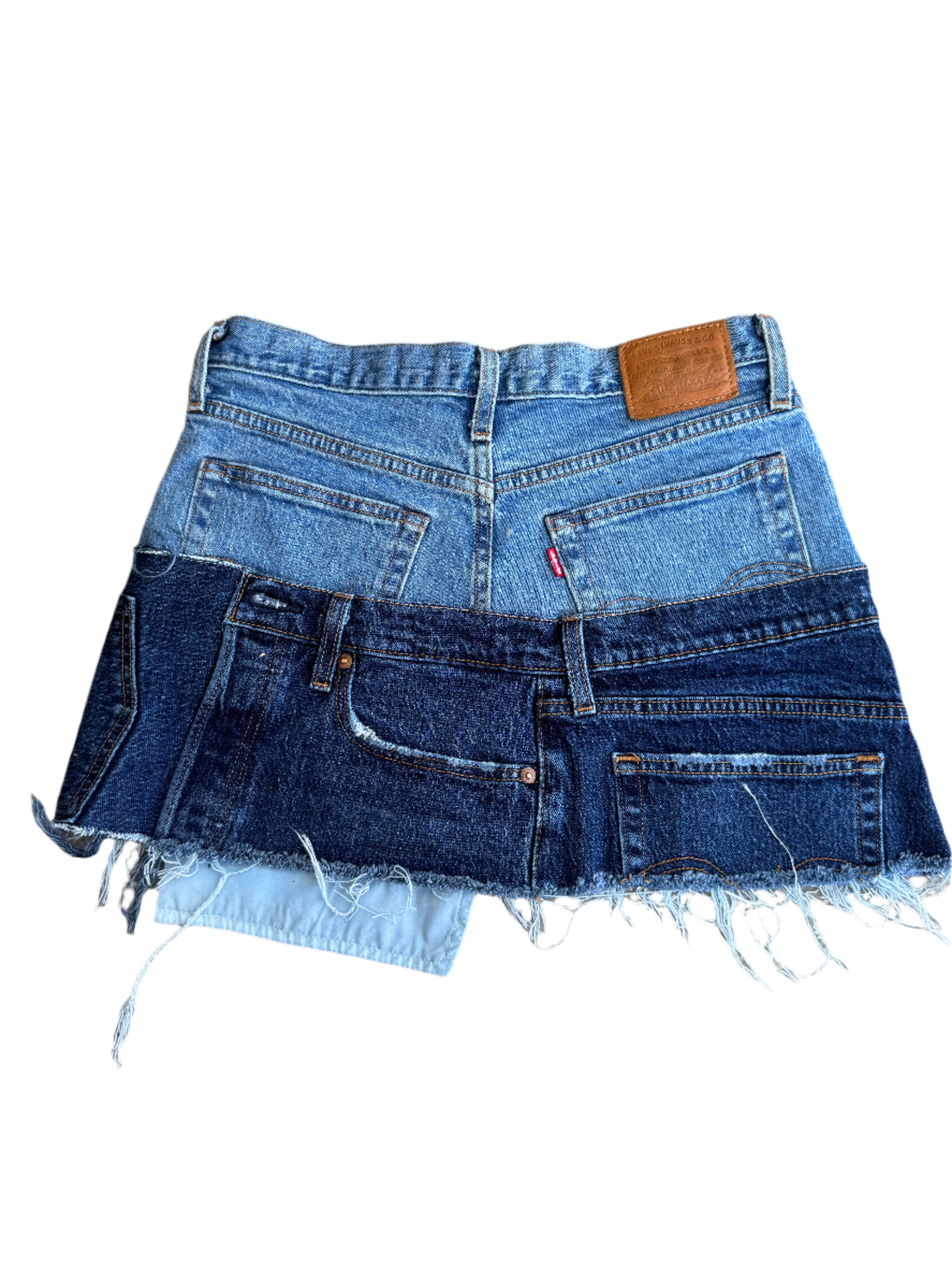 Stack of denim jeans on a concrete surface