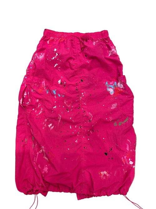 Pink skirt with colorful splatter pattern on a white background