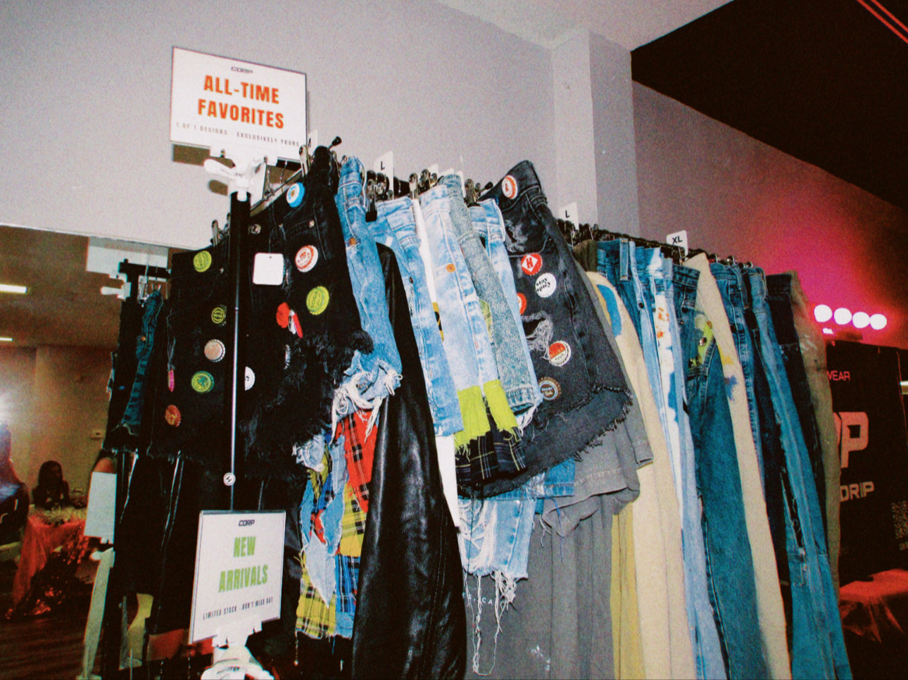 Display of colorful jeans with a 'All Time Favorites' sign in the background.