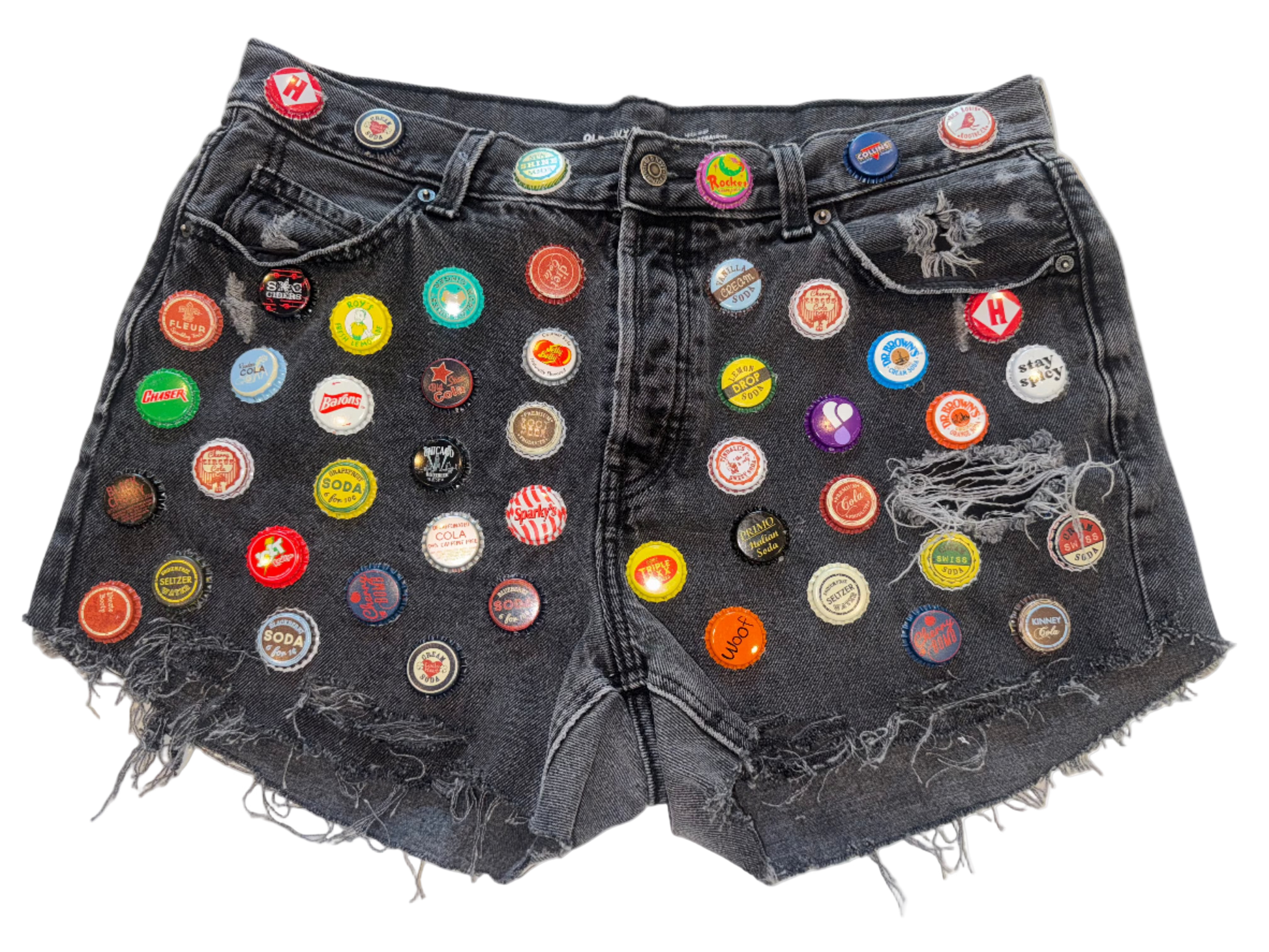 Black denim shorts with colorful bottle caps attached 