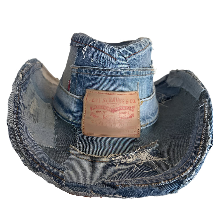 Handcrafted upcycled denim cowboy hat made from vintage Levi’s jeans, featuring distressed edges, visible stitching, and an authentic Levi’s leather patch. Sustainable streetwear accessory blending Western fashion with bold urban style, available exclusively at Creative Drip.