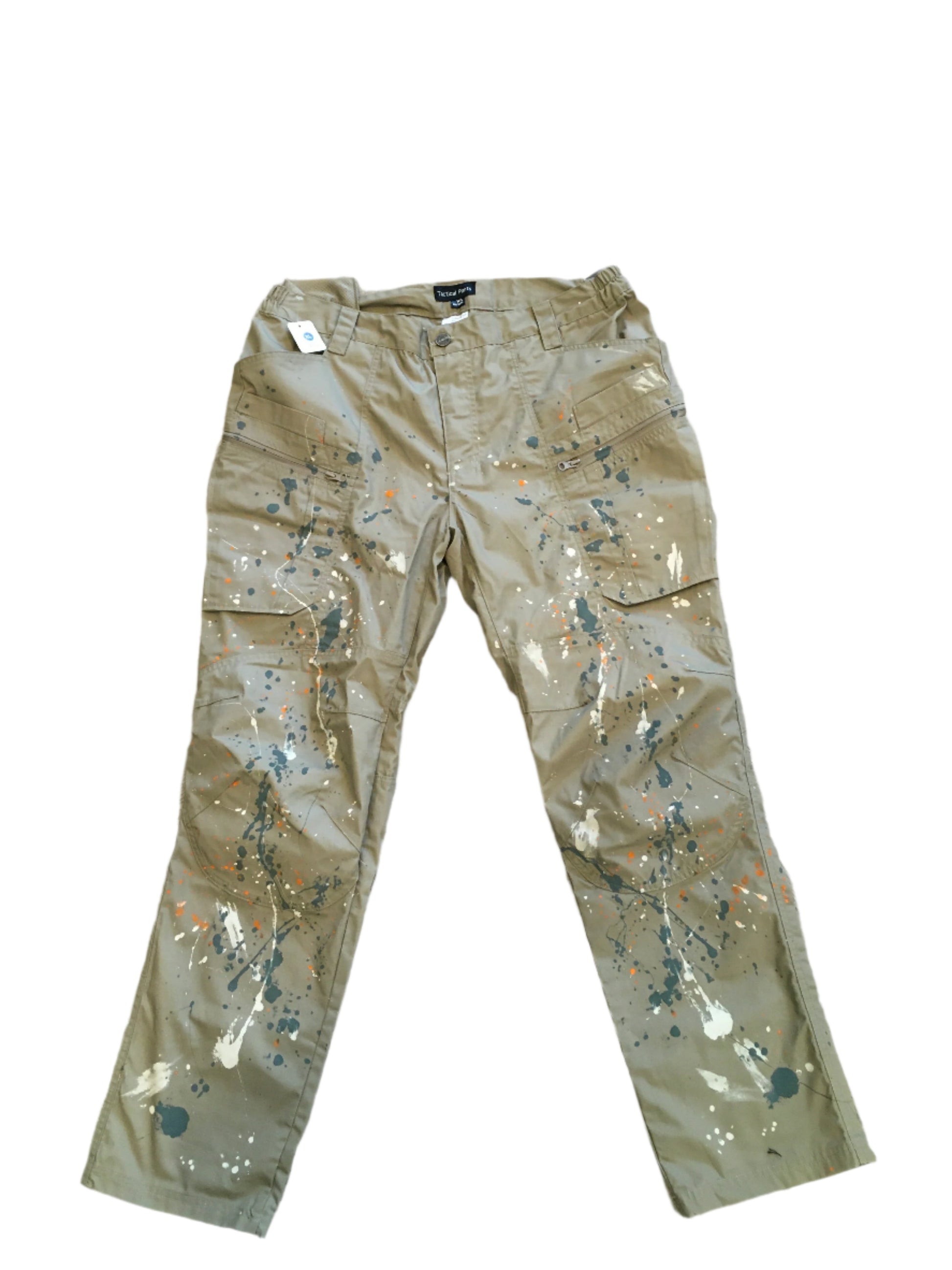 Khaki cargo tactical pants featuring bold paint splatter details. Designed with multiple pockets and a comfortable fit, perfect for a casual, edgy look.